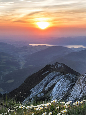 An orange and pink sunrise over a mountain top