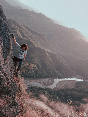 A person climbing the side of a mountain